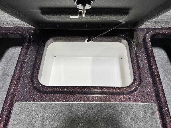Slide: The Image of 2024 Skeeter ZX150 boat storage compartment with open lid. - 11