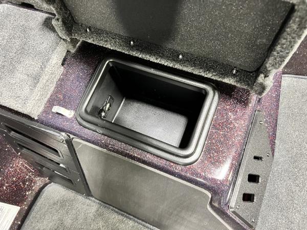 Slide: The Image of 2024 Skeeter ZX150 storage compartment with open lid. - 13