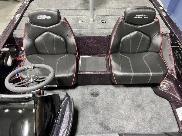 Slide: The Image of 2024 Skeeter ZX150 boat interior with black leather seats and steering wheel. - 14