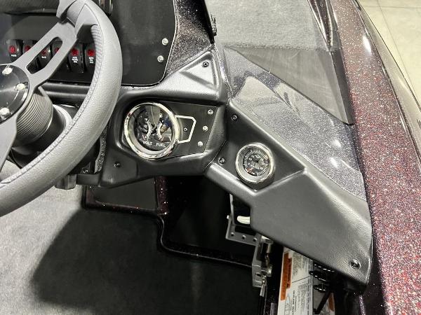 Slide: The Image of 2024 Skeeter ZX150 boat dashboard with steering wheel and gauges. - 16