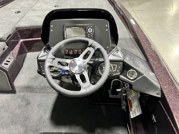 Slide: The Image of 2024 Skeeter ZX150 boat dashboard with steering wheel and control panel. - 17