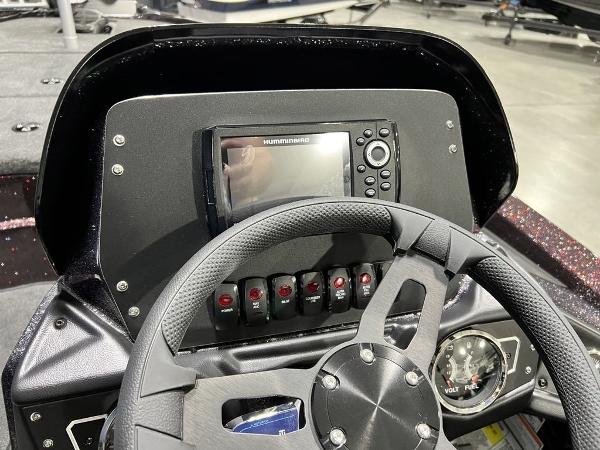 Slide: The Image of 2024 Skeeter ZX150 boat dashboard with steering wheel and electronic display. - 18