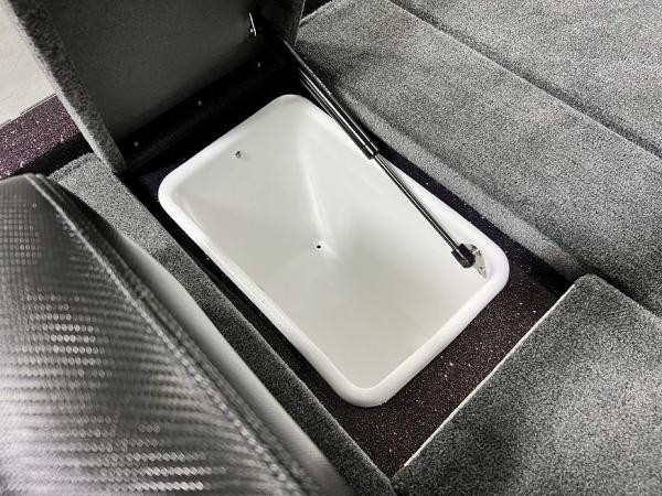 Slide: The Image of 2024 Skeeter ZX150 boat storage compartment with open lid and hydraulic lift. - 21