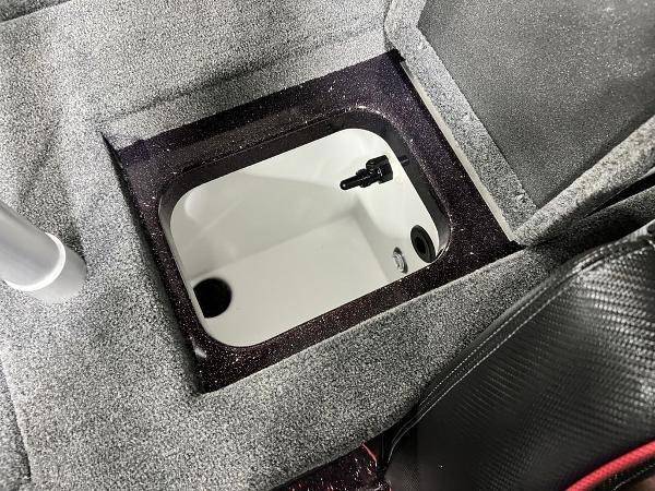 Slide: The Image of 2024 Skeeter ZX150 boat storage compartment with open hatch. - 22