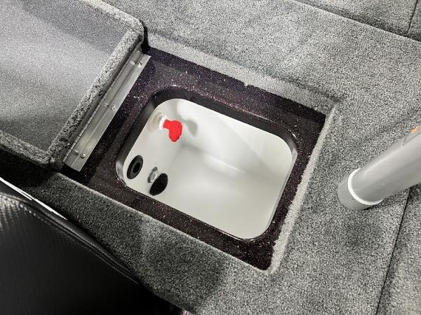 Slide: The Image of 2024 Skeeter ZX150 boat storage compartment with open lid. - 23
