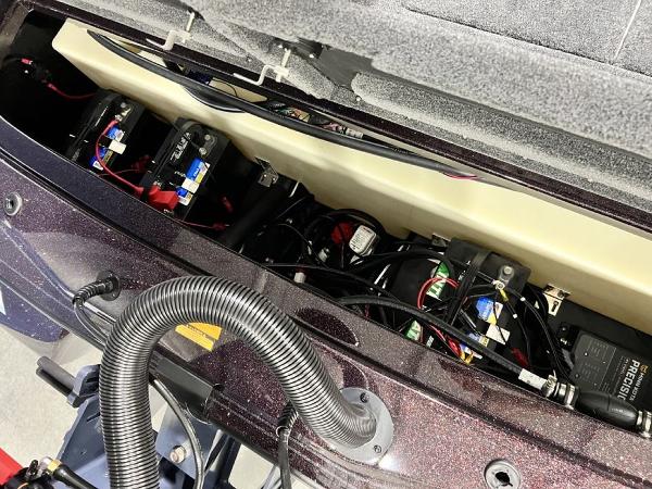 Slide: The Image of 2024 Skeeter ZX150 boat battery compartment with wiring and components. - 25