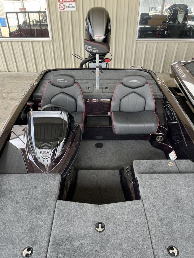 Slide: The Image of 2024 Skeeter ZX150 boat interior with dual seats and motor. - 3