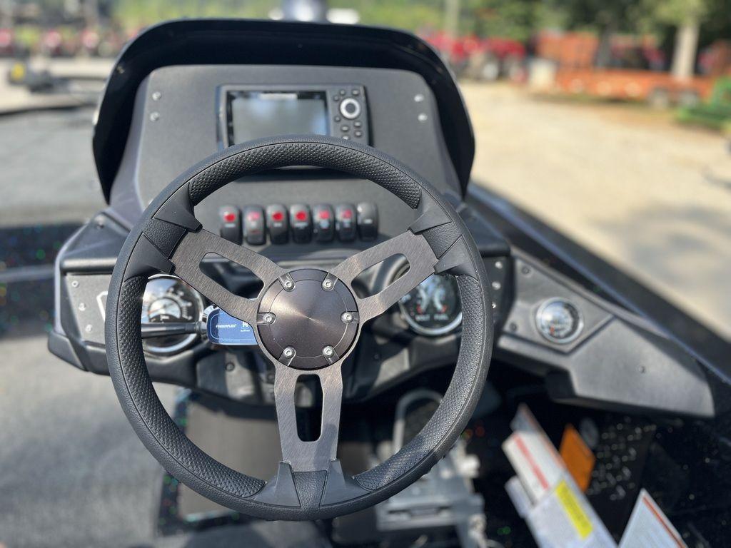 Slide: The Image of 2024 Skeeter ZX150 boat dashboard with steering wheel and control panel. - 4
