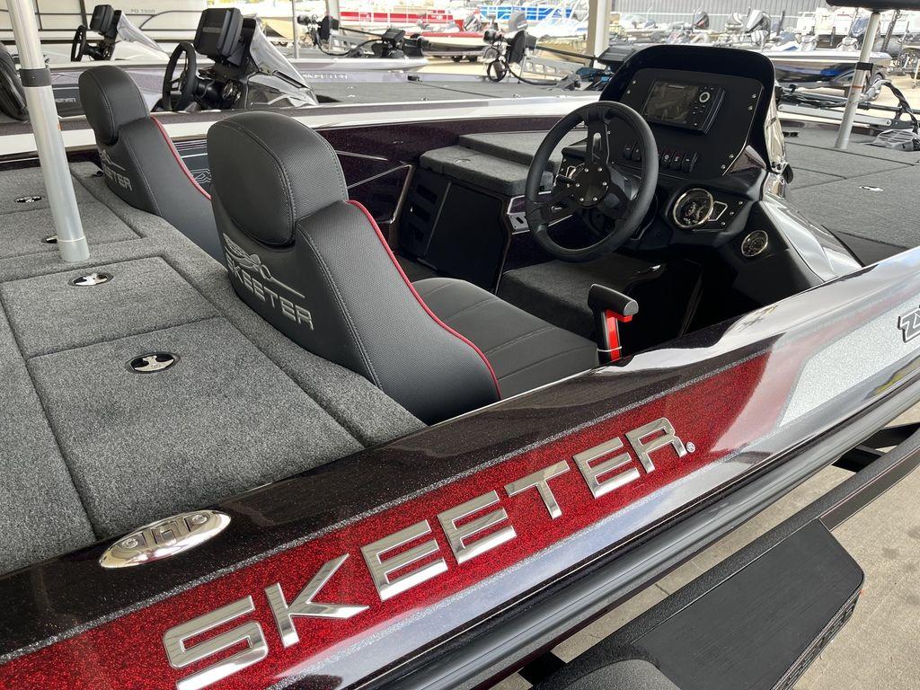 Slide: The Image of 2024 Skeeter ZX150 boat interior with steering console and seating. - 4