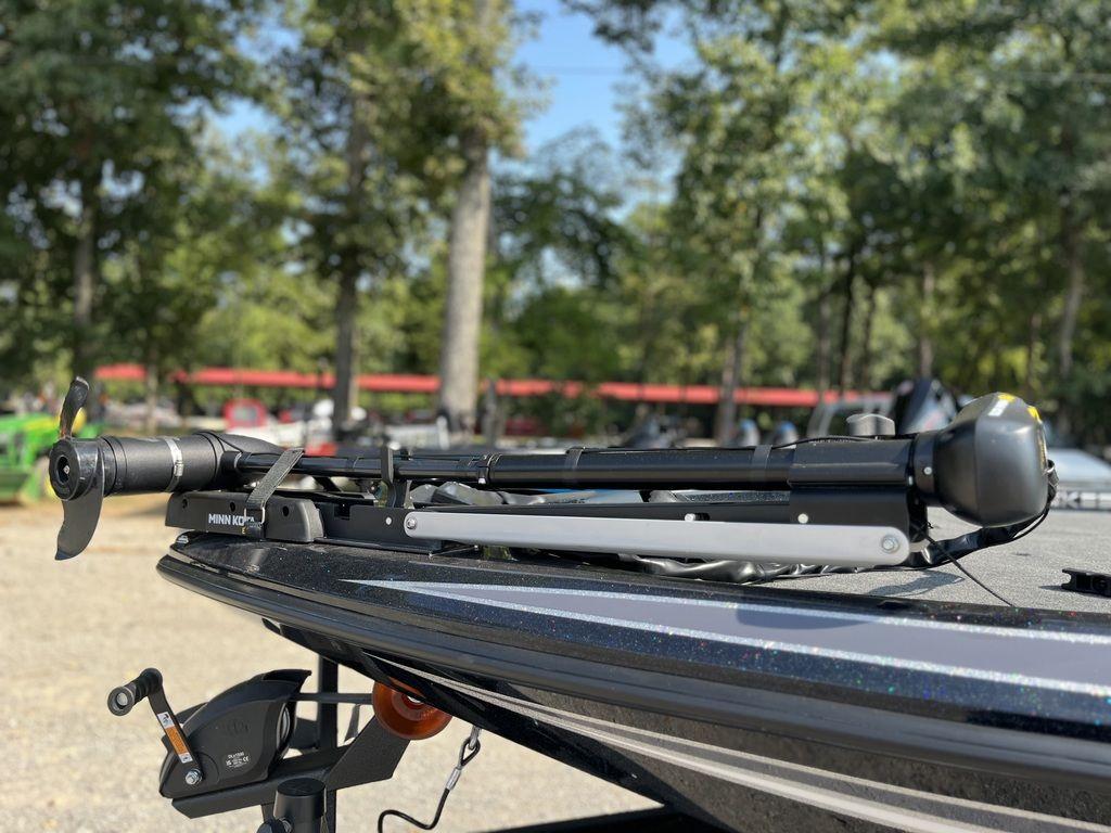 Slide: The Image of 2024 Skeeter ZX150 boat with Minn Kota trolling motor in a wooded area. - 5