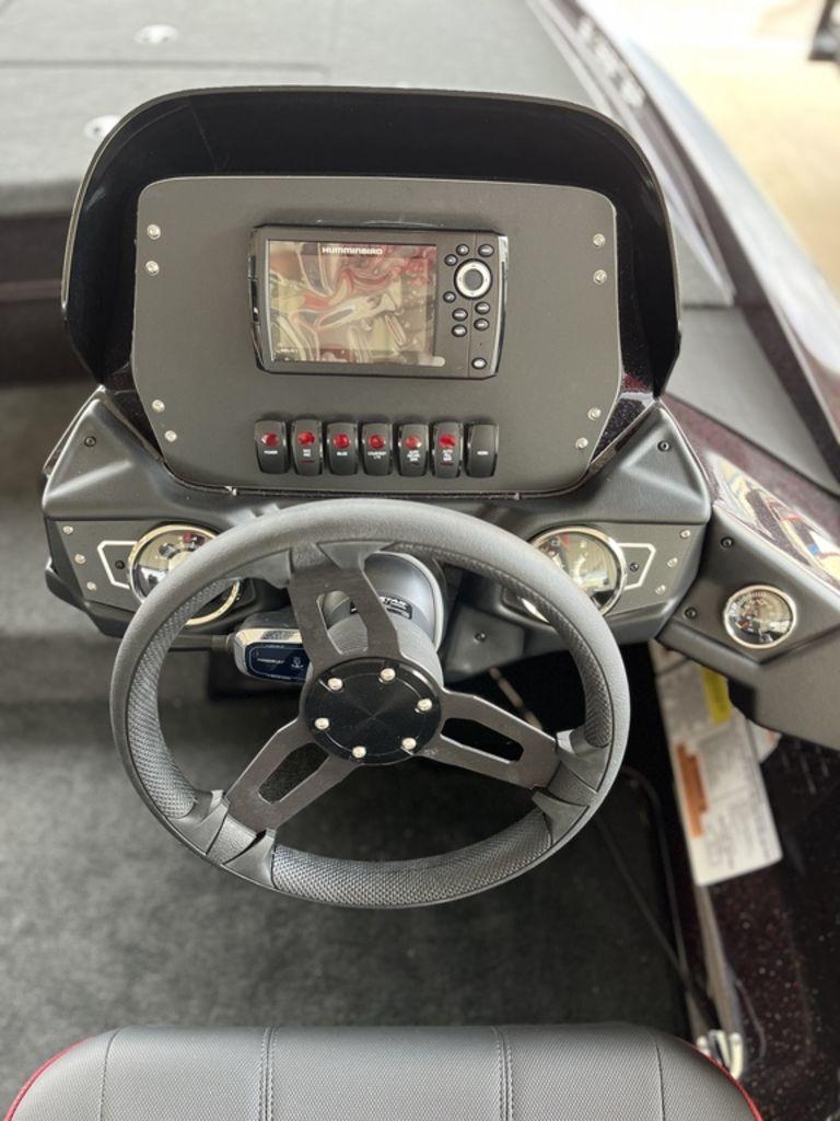 Slide: The Image of 2024 Skeeter ZX150 boat dashboard with steering wheel and electronic display. - 5
