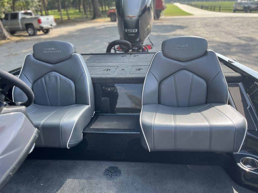 Slide: The Image of 2024 Skeeter ZX150 boat interior with dual gray seats and 150 HP engine. - 7