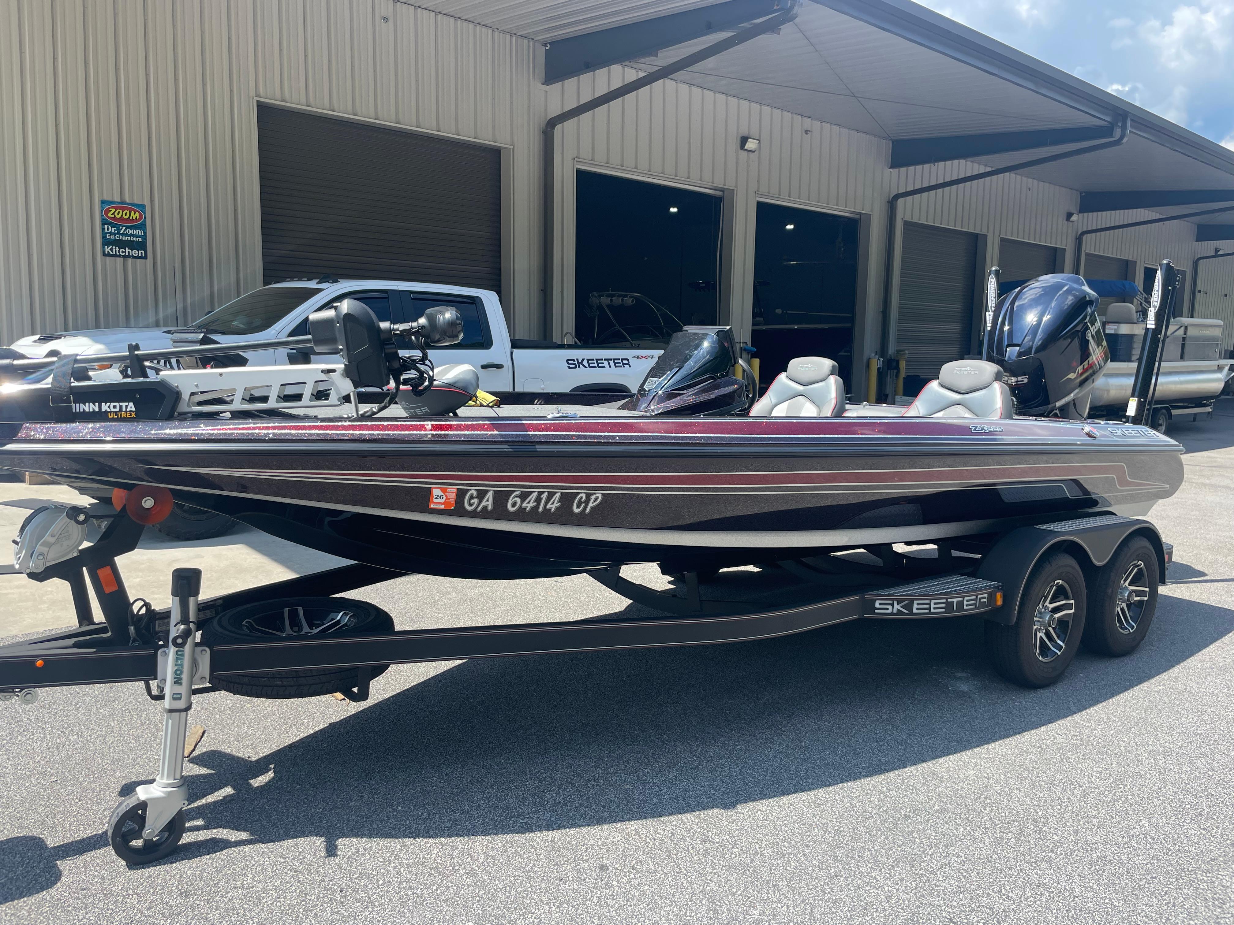 Slide: The Image of 2020 Skeeter ZX 225 boat on trailer, parked outside a building. - 0