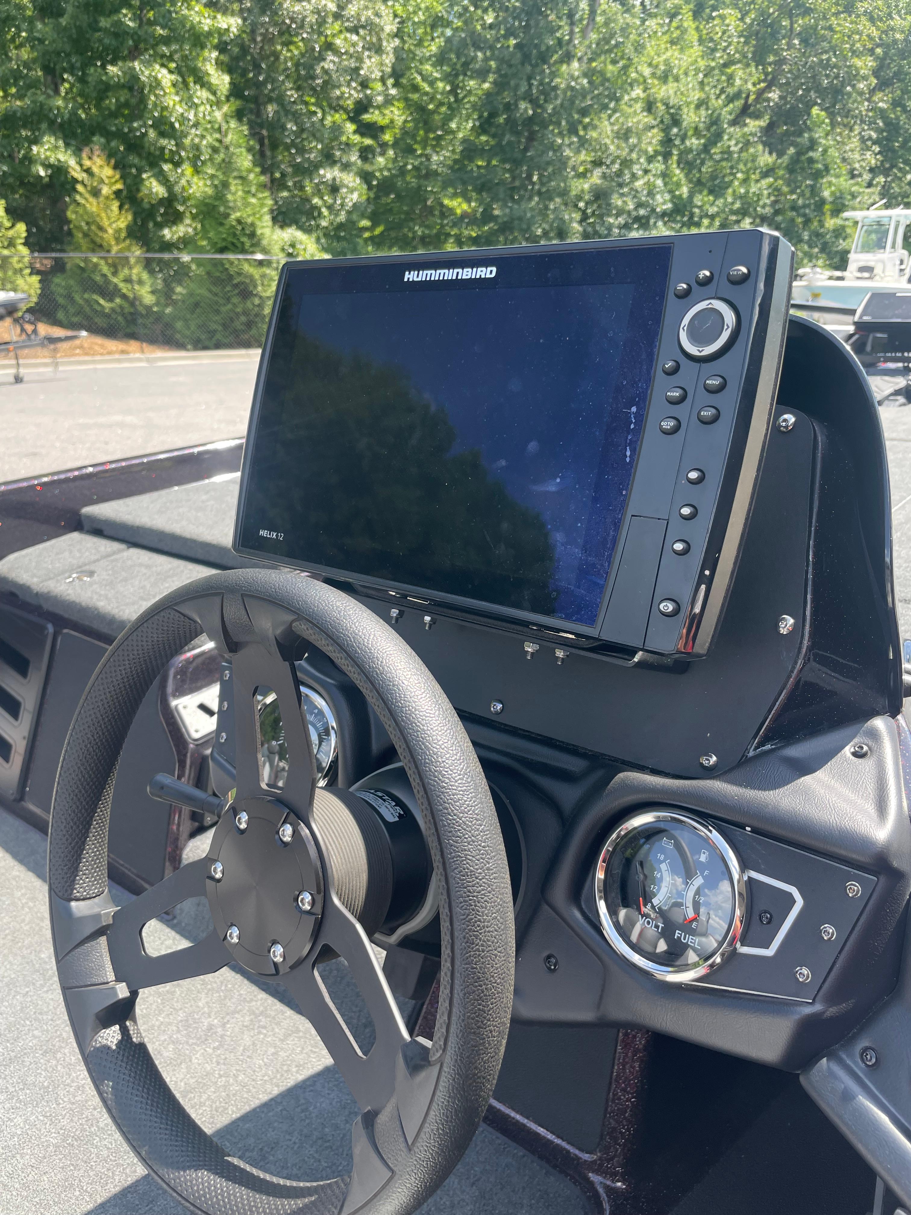 Slide: The Image of 2020 Skeeter ZX 225 boat dashboard with Humminbird display and steering wheel. - 14