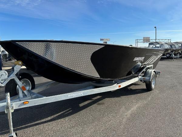 Slide: The Image of 2024 Smoker Craft 1872 PRO SPORTSMAN TL boat on a trailer in a parking lot. - 0