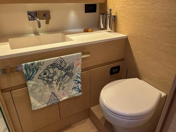 Slide: The Image of Modern bathroom in 2024 Solaris Power 52 Open yacht with sink and toilet. - 17