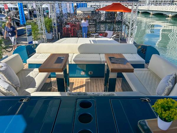 Slide: The Image of 2024 Solaris Power 52 Open luxury yacht interior with seating and tables at a marina. - 25