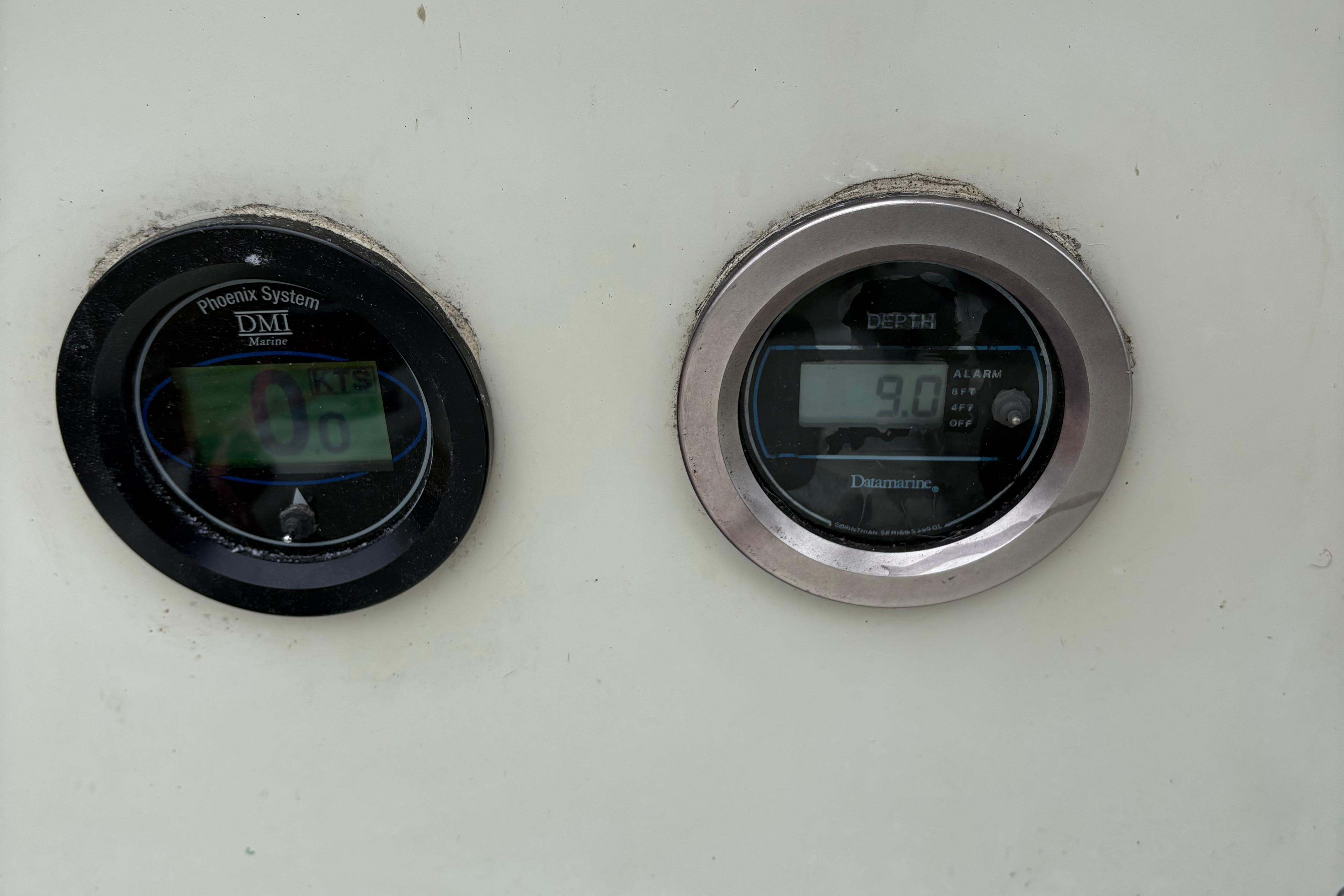 Slide: The Image of Boat dashboard with Phoenix System and Datamarine depth gauges, Sonic 23, 1983 model. - 11