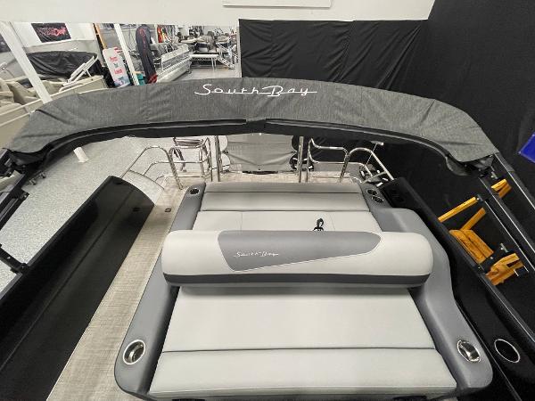 Slide: The Image of 2023 South Bay S224 UL pontoon boat with gray seating and canopy. - 10