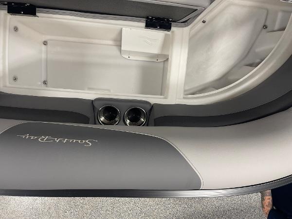 Slide: The Image of 2023 South Bay S224 UL boat interior with storage compartment and cup holders. - 13