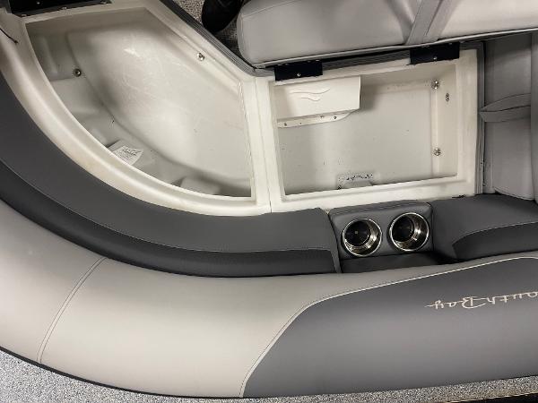 Slide: The Image of 2023 South Bay S224 UL boat interior with storage compartment and cup holders. - 14