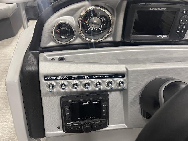 Slide: The Image of 2023 South Bay S224 UL boat dashboard with gauges, switches, and Lowrance display. - 8