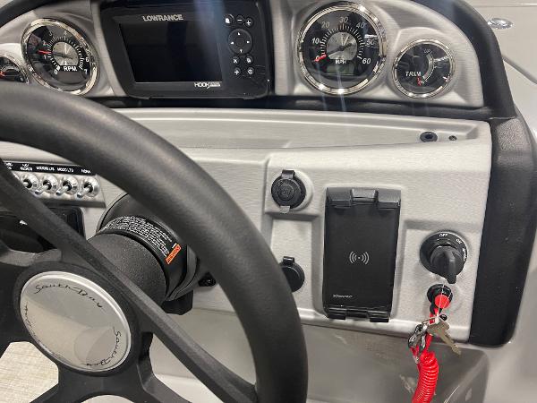Slide: The Image of 2023 South Bay S224 UL boat dashboard with steering wheel, gauges, and control panel. - 9