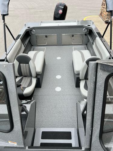 Slide: The Image of 2024 Spartan 185 Astoria boat interior with seating and motor. - 4