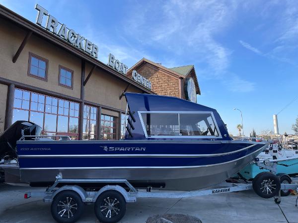 Slide: The Image of 2024 Spartan 200 Astoria boat on trailer outside Tracker Boat Center. - 0