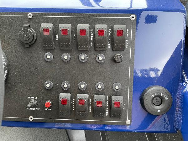 Slide: The Image of Control panel of a 2024 Spartan 200 Astoria boat with various switches and buttons. - 10