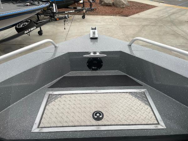 Slide: The Image of 2024 Spartan 200 Astoria boat bow with storage compartment and anchor mount. - 14