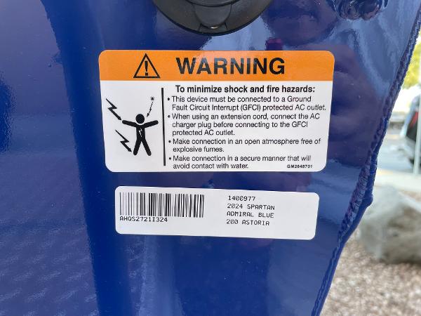 Slide: The Image of 2024 Spartan 200 Astoria warning label on Admiral Blue surface. - 21