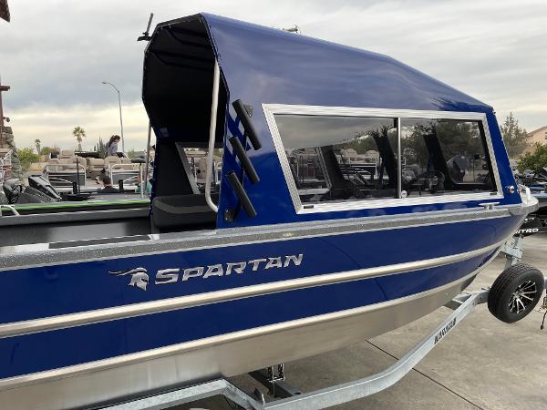 Slide: The Image of 2024 Spartan 200 Astoria boat with blue canopy on trailer. - 3