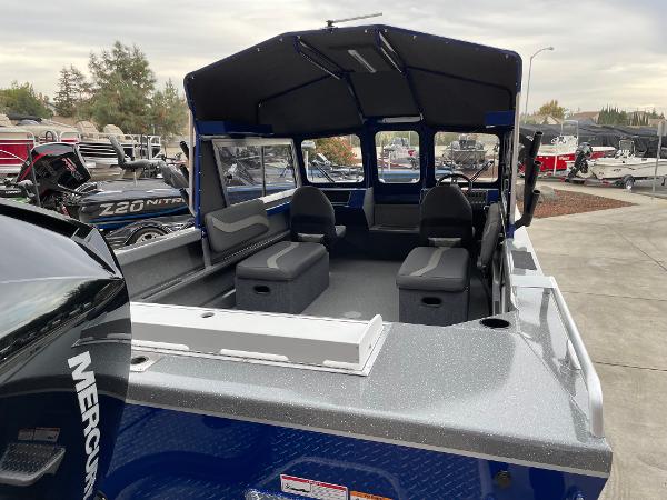 Slide: The Image of 2024 Spartan 200 Astoria boat interior with seating and Mercury engine. - 5