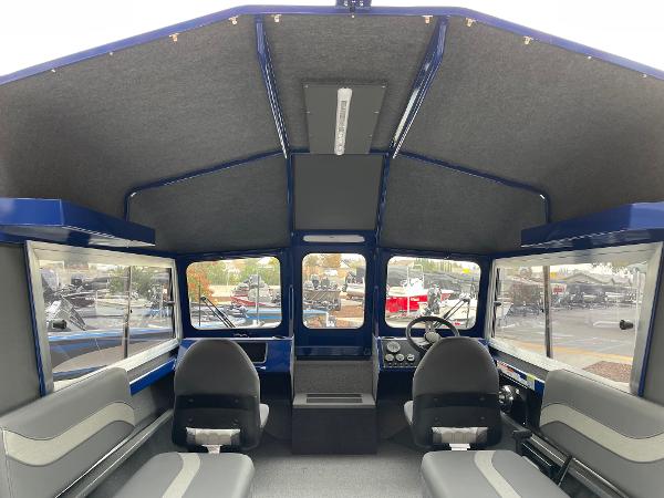 Slide: The Image of Interior of 2024 Spartan 200 Astoria boat with seating and steering console. - 6