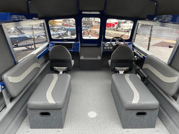 Slide: The Image of 2024 Spartan 200 Astoria boat interior with seating and steering console. - 7