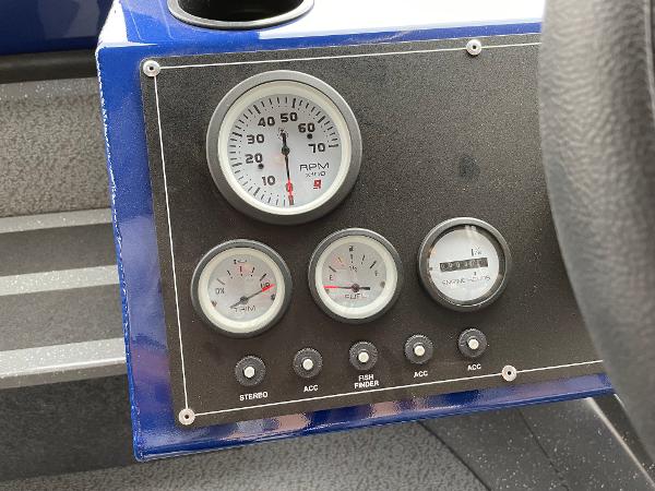 Slide: The Image of Dashboard gauges and controls of a 2024 Spartan 200 Astoria boat. - 8