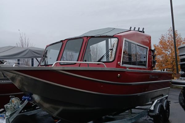 Slide: The Image of 2024 Spartan 215 Athens boat in red, parked on a trailer. - 1