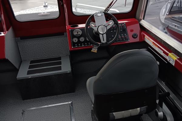 Slide: The Image of 2024 Spartan 215 Athens boat interior with steering wheel and control panel. - 5