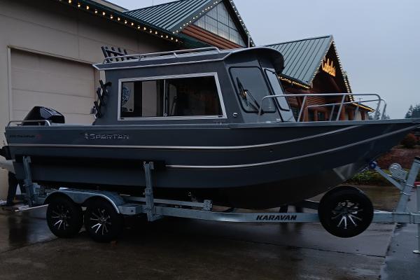Slide: The Image of 2024 Spartan 220 Maximus Pro boat on Karavan trailer. - 1