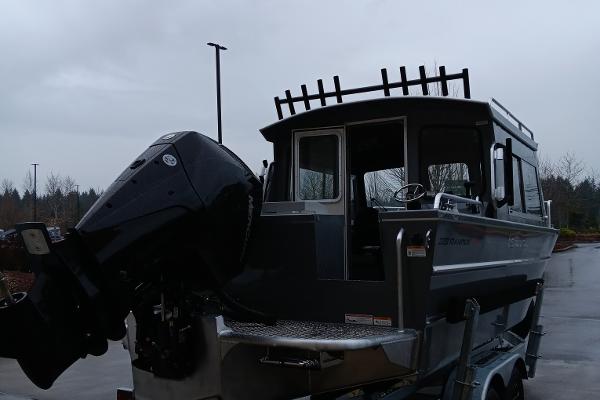 Slide: The Image of 2024 Spartan 220 Maximus Pro boat with outboard motor on trailer. - 2