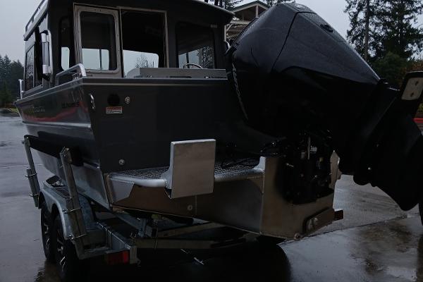 Slide: The Image of 2024 Spartan 220 Maximus Pro boat on trailer, rear view with outboard motor. - 3