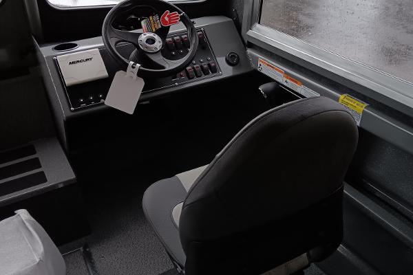 Slide: The Image of 2024 Spartan 220 Maximus Pro boat cockpit with steering wheel and control panel. - 4