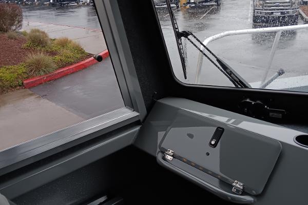 Slide: The Image of Interior view of 2024 Spartan 220 Maximus Pro boat on a rainy day. - 6