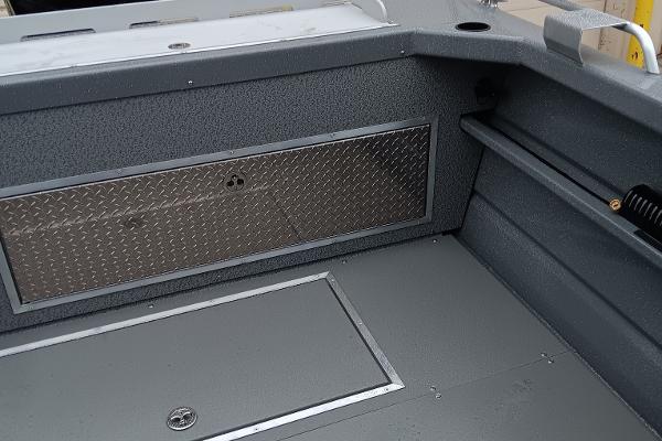 Slide: The Image of 2024 Spartan 220 Maximus Pro boat interior with diamond plate storage compartment. - 7