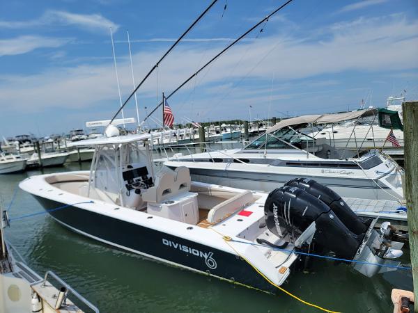 Slide: The Image of 2018 Spectre 35 Center Console by Pilini docked at marina with twin outboard engines. - 1