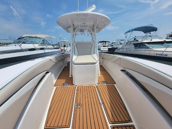 Slide: The Image of 2018 Spectre 35 Center Console by Pilini, teak deck, docked among other boats. - 11