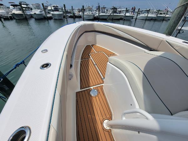 Slide: The Image of 2018 Spectre 35 Center Console by Pilini, docked with teak flooring and white seating. - 12
