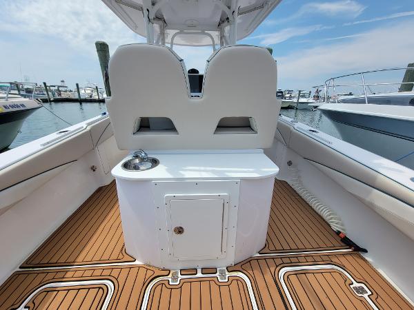 Slide: The Image of 2018 Spectre 35 Center Console by Pilini, teak deck, marina background. - 13