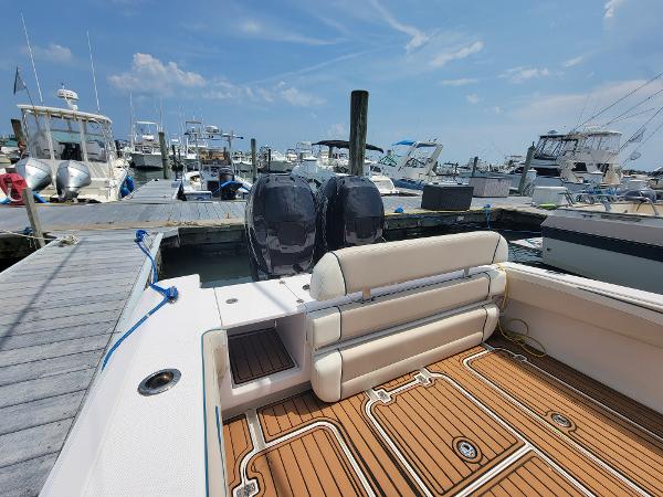Slide: The Image of 2018 Spectre 35 Center Console by Pilini docked at a marina, featuring twin outboard motors. - 14